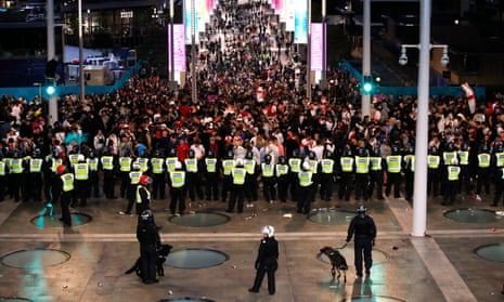 Police form a cordon around England fans outside Wembley before the Euro 2020 final.