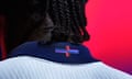 The back of a man's head who is wearing the new England football shirt featuring a multicoloured Saint George’s cross