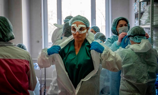 Medical workers get ready for a shift treating coronavirus patients in Moscow