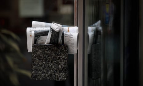 Canadian newspapers stuffed into a door handle.