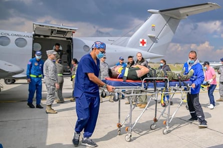Paramedics receive an injured person at CATAM airbase in Bogotá, Colombia.