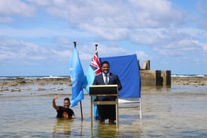Tuvalu’s minister for justice, communication and foreign affairs, Simon Kofe, gives a Cop26 statement while standing in the ocean in Funafuti, Tuvalu.