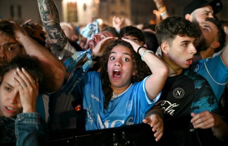 A Napoli supporter reacts as she watches the Italian Serie A football match between Napoli and Cagliari