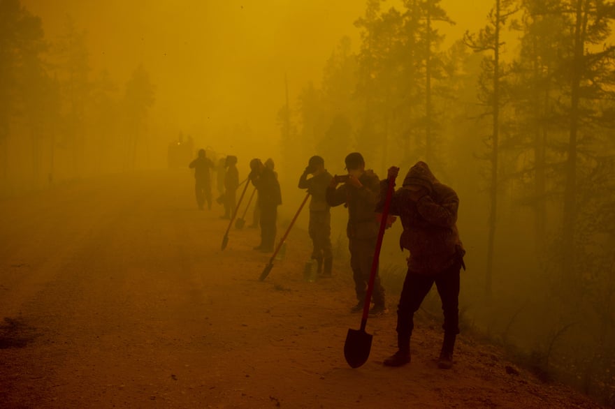 Volunteers working at the scene of a forest fire in Siberia in August 2021.