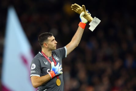 Emiliano Martínez parades his Golden Gloves to the Aston Villa fans.