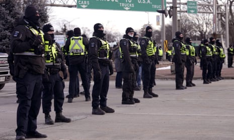 Police line up in preparation on the bridge in Windsor, Ontario, on 12 February. 