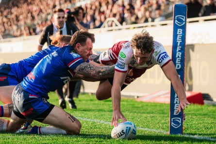 Noah Hodkinson dives over to score for Wigan.