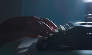 Close-up of woman using typewriter