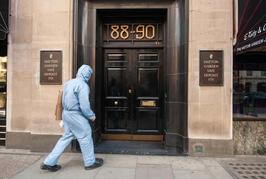A police forensics officer enters the Hatton Garden Safe Deposit company, scene of the biggest burglary in English history.