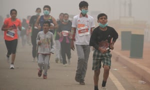Indian children run in smog