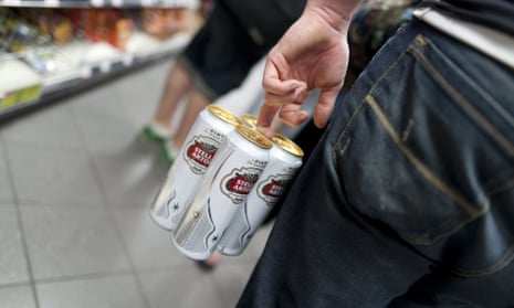 four pint cans of Stella Artois held together by a pack ring and being carried by a young man in a shop