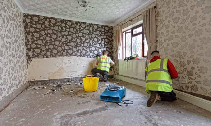 Builders work in a flood-damaged house in Porth, Rhondda Cynon Taff