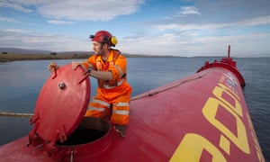 a man aboard a pelamis wave power converter