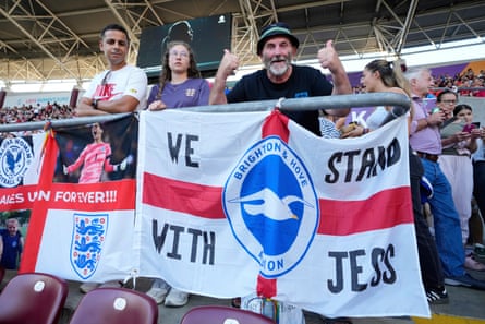 Fans with an England flag that says ‘We stand with Jess Carter’.
