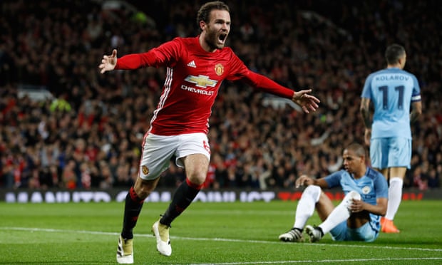 Manchester United’s Juan Mata celebrates scoring their first goal and the United crowd are pretty happy too.