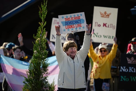 Demonstrators hold signs and cheer by the roadside as a part of a No Kings protest on March 28, 2026 in Shelbyville, Kentucky.