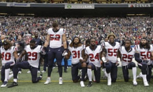 Houston Texans players kneel and stand during the singing of the national anthem
