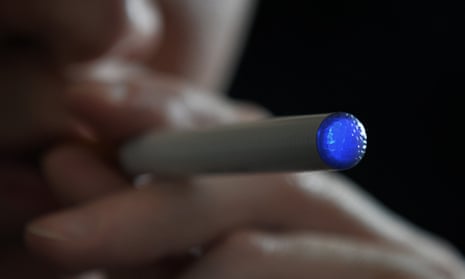 A person using an e-cigarette