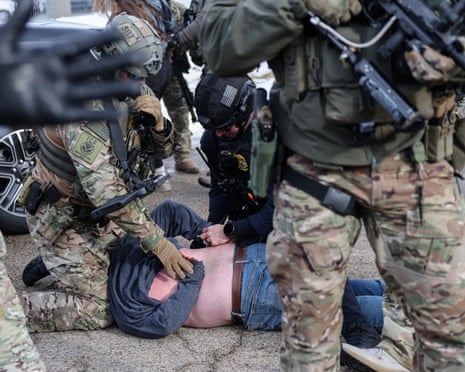 ICE agents detain a protester outside the Bishop Henry Whipple Federal Building during a demonstration against increased immigration enforcement in Minneapolis, 9 January 2026.