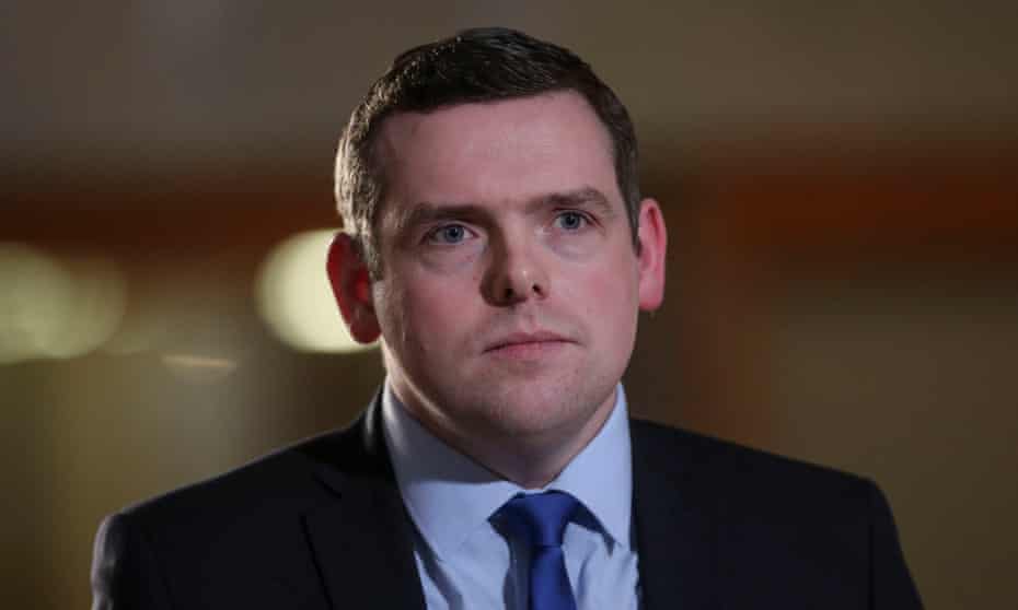 Head and shoulders photograph of Douglas Ross in a  suit, blue shirt and blue tie