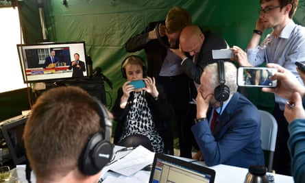 Jeremy Corbyn watches David Cameron on a screen as he speaks outside 10 Downing Street.