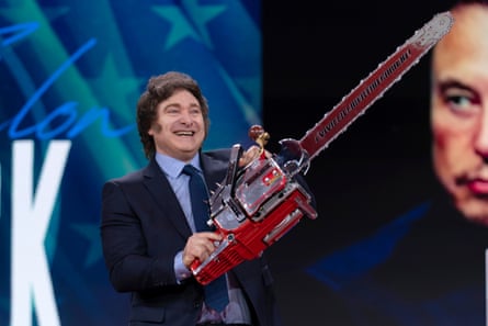 Javier Milei, with Elon Musk's image behind, waves a chainsaw onstage at CPAC in February.