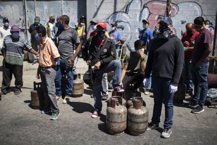People from El Valle de Caracas parish queue for eight hours to buy a cylinder of butane gas during the second week of the national quarantine in Caracas, Venezuela, in late March.