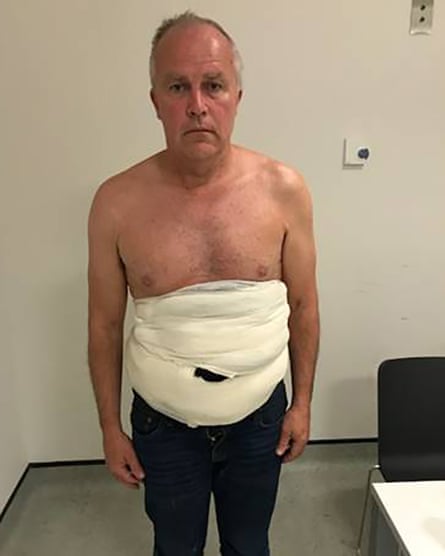 Jeffrey Lendrum with bird eggs strapped to his body in a sling after arriving in the UK at Heathrow Airport on June 2018.