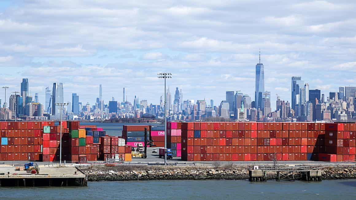 Shipping containers at the Port Jersey container terminal, with the Manhattan skyline in the distance.