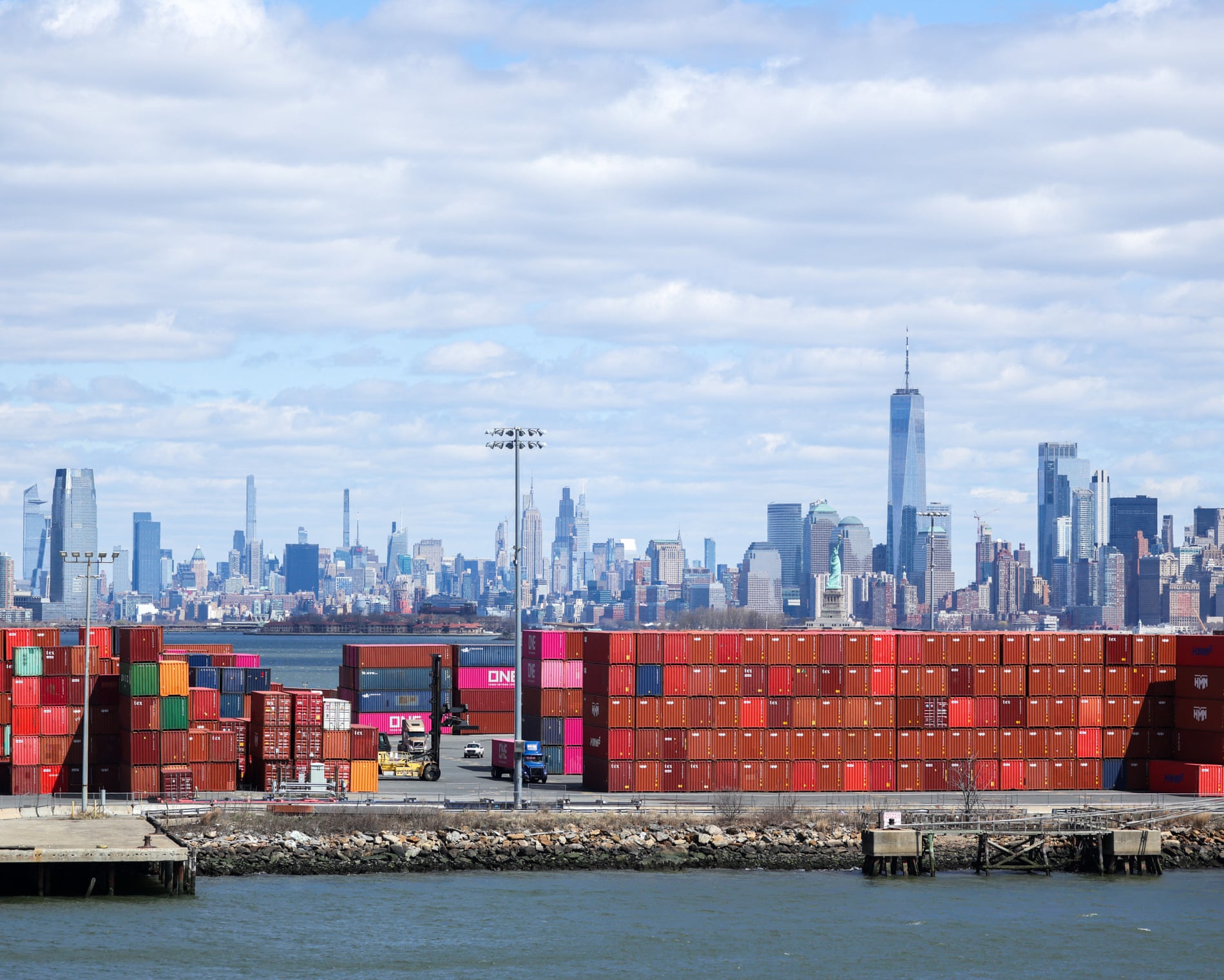 Shipping containers the Port Jersey container terminal, with the Manhattan skyline in the distance.