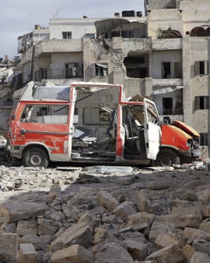 A destroyed ambulance is seen outside the Syrian Civil Defence HQ after airstrikes in Ansari.