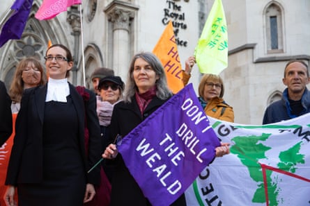 Holding a purple flag emblazoned with the slogan ‘Don’t drill the weald’, Sarah Finch and her supporters stand outside the Court of Appeal