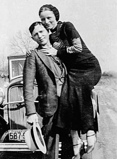 black and white photo of a man picking up a woman