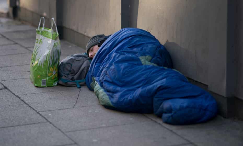 A homeless person sleeping on the streets