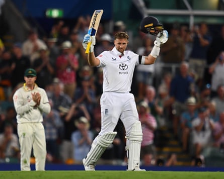The England batter Joe Root raises his bat to celebrate scoring a century in the fifth and final Test of the 2025/26 Ashes at the Sydney Cricket Ground.