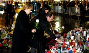 Paris mayor Anne Hidalgo accompanies German Chancellor Angela Merkel and French President Francois Hollande as they show their respects to the victims of the November terror attacks.
