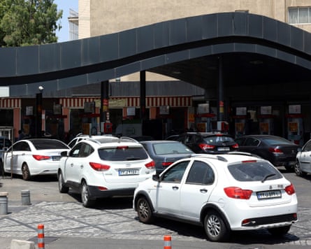 Iranians queue with their vehicles at a petrol station after Israeli strikes on Tehran.