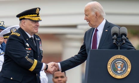 Joe Biden shakes hands with outgoing Joint Chiefs Chairman Gen. Mark Milley.