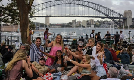People gather as they celebrates the New Year’s Eve, 31 December 2022 in Sydney, Australia.