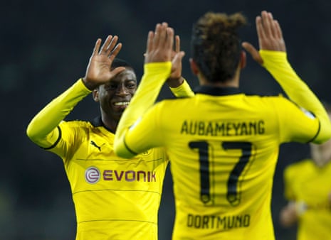 Two players give each other high-fives in the Borussia Dortmund v VfB Stuttgart match last month