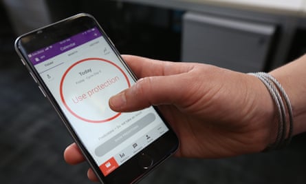A women demonstrates using the Natural Cycles smartphone app