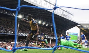Danny Welbeck rounds Joel Robles to open the scoring for Arsenal.