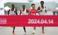 Chinese runner He Jie, Ethiopian Dejene Hailu Bikila and Kenyans Robert Keter and Willy Mnangat cross the line in the Beijin half-marathon.