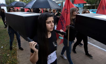A young Israeli woman carries a coffin during a protest held by family members and friends of women killed by violence in Tel Aviv, Israel.