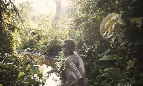 A Mbuti Indigenous boy runs through the Ituri rainforest in the Democratic Republic of the Congo