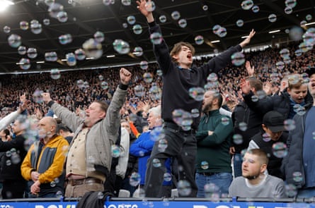 West Ham fans in the Billy Bonds Stand singing as bubbles fly just before kick off