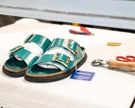 Green patent Birkenstocks with gold buckles
