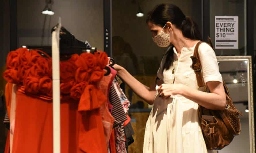 A shopper browsing through secondhand clothes