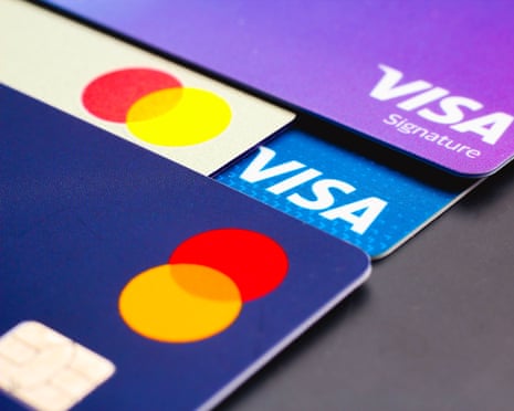 A close-up view of a Visa Signature, two Mastercards and a Visa credit card.