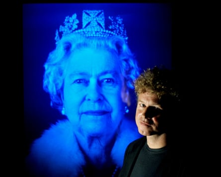 Chris Levine standing in front of an image of Queen Elizabeth II
